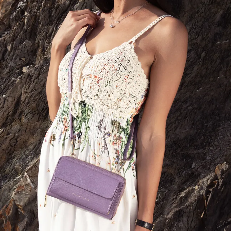 Woman wearing a Tuscany Leather crossbody bag